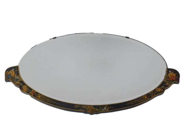 An early 20thC black japanned lacquer part framed oval wall mirror