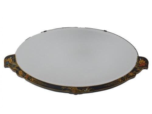 An early 20thC black japanned lacquer part framed oval wall mirror