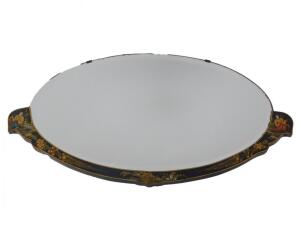 An early 20thC black japanned lacquer part framed oval wall mirror