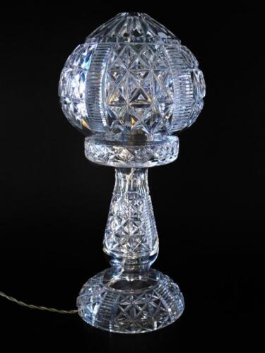 A cut glass table lamp and shade