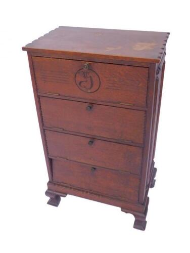 An early 20thC oak music cabinet