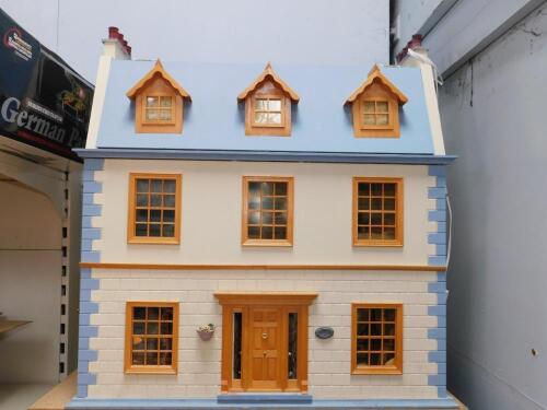 A cream and grey painted double fronted dolls house