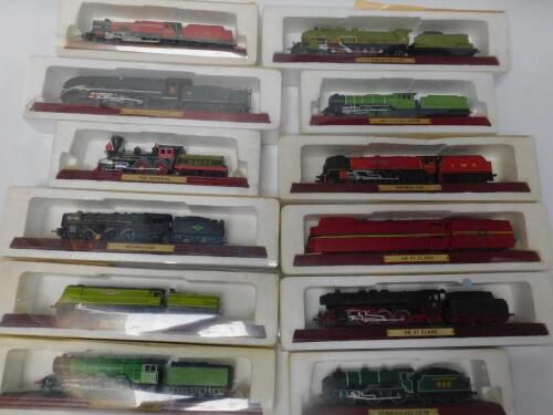 Die cast models of locomotives and tenders on integral tracked stands