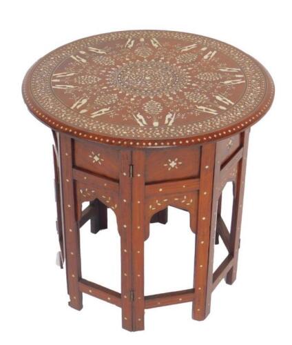 An Indian early 20thC hardwood and ivory inlaid folding occasional table