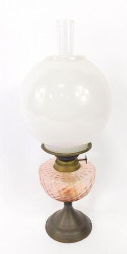 An early 20thC tin and glass oil lamp