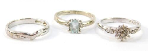 A 9ct white gold and diamond flower head ring