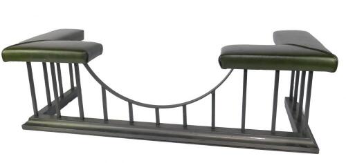 A cast iron and green leather club fender