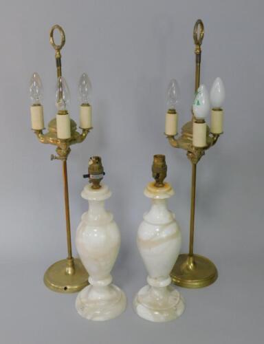 A pair of brass three light table lamps