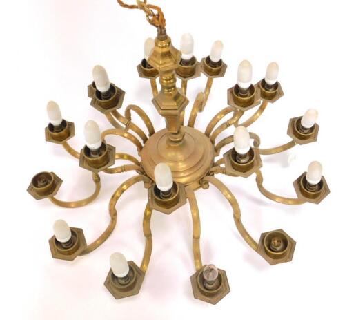 A 17thC style brass eighteen branch two tier chandelier.