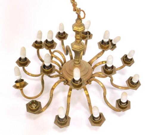 A 17thC style brass eighteen branch two tier chandelier.