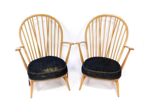 A pair of Ercol beech and elm stick back fireside chairs