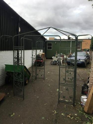 A green cast iron four sided garden arbour