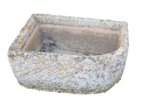 A hand hewn bull-nose stone trough