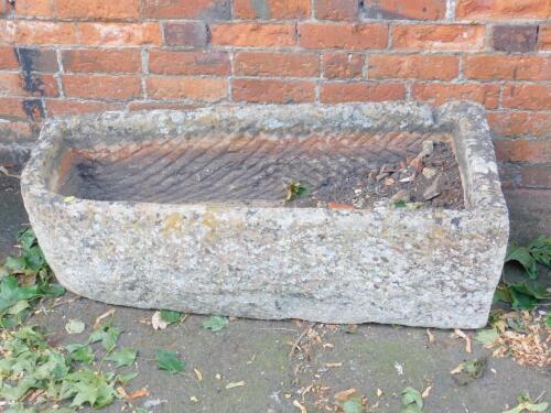 A hand hewn bull-nose stone trough