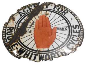 A RUDGE-WHITWORTH CYCLES enamel advertising sign, circular with central red hand, white ground...