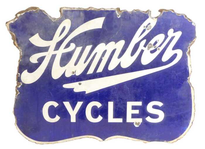 A Humber CYCLES enamel advertising sign, of shield form, navy ground, double-sided, 45cm x 60cm....