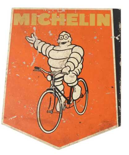 A MICHELIN painted metal advertising sign, depicting the Michelin Man on a bicycle, red ground,...