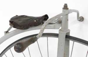 A penny farthing or ordinary bicycle, the painted grey frame with a partial leather seat, and... - 3