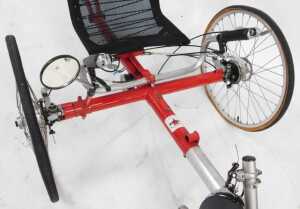 A Trice recumbent tricycle, on a red frame, with a black mesh seat, lacking pedals, 200cm wide. - 4