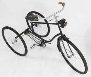 A tricycle, the black painted frame with steel and orange plastic capped handlebars, with a... - 3