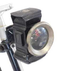 A tricycle, the black painted frame with steel and orange plastic capped handlebars, with a... - 4