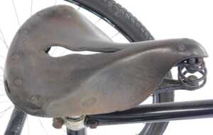 A tricycle, the black painted frame with steel and orange plastic capped handlebars, with a... - 6