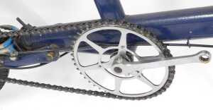 A Moulton bicycle, the royal blue frame with a black seat, lacking pedals, on a single bicycle... - 5