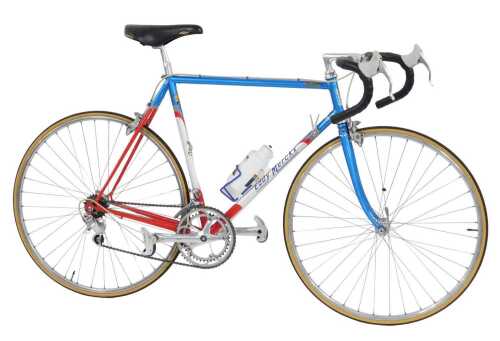 An Eddy Merckx bicycle, with a red, blue and white Columbus SL frame, with applied labels and...