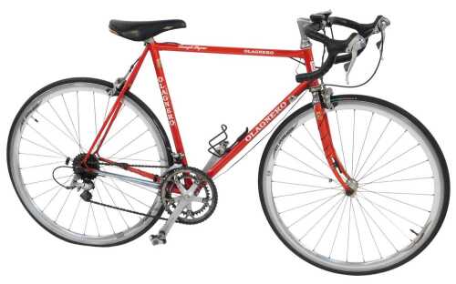 An Olagnero bicycle, the red Columbus Cara frame, with bound handlebars and Shimano 105 brakes,...