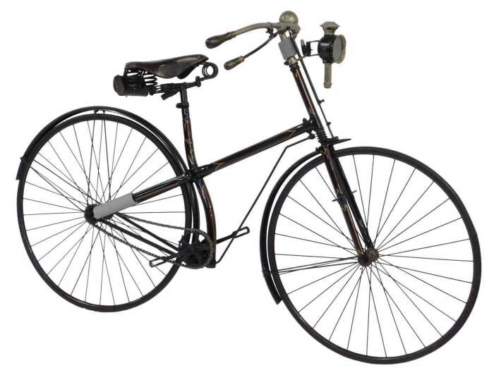 A late 19thC bicycle, the later black, gold and red painted frame with turned wooden capped...