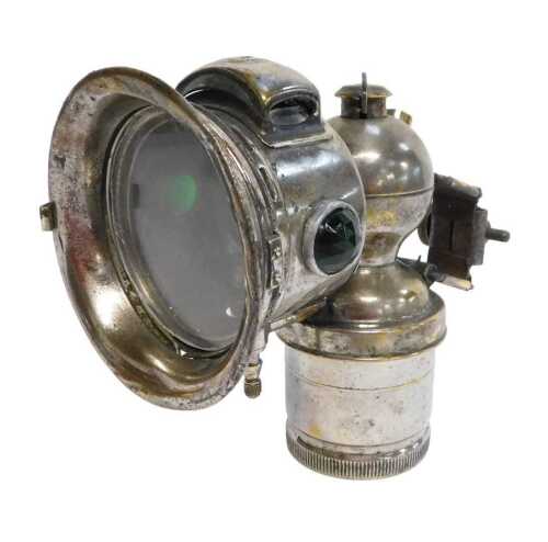 A Miller Bola carbide/acetylene bicycle lamp, each side inset with a faceted red and green glass...