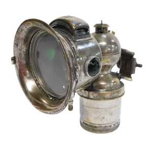 A Miller Bola carbide/acetylene bicycle lamp, each side inset with a faceted red and green glass...