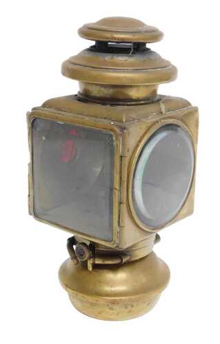 An E&J Detroit brass effect car paraffin side light, inset with a faceted red glass roundel,...
