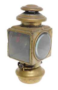 An E&J Detroit brass effect car paraffin side light, inset with a faceted red glass roundel,...