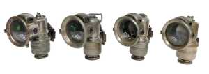 Four Powell and Hanmer Ltd Birmingham carbide/acetylene bicycle lamps, each inset with red and...