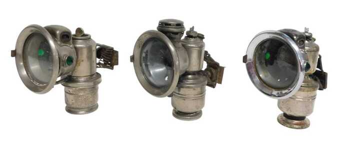 Three Powell and Hanmer Ltd Birmingham Panther carbide/acetylene bicycle lamps, two inset with...