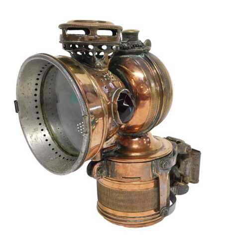 A Twentieth Century American copper and brass carbide/acetylene bicycle lamp, inset with green...