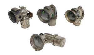 Four Miller Bola carbide/acetylene bicycle lamps, each inset with faceted green glass roundels,...