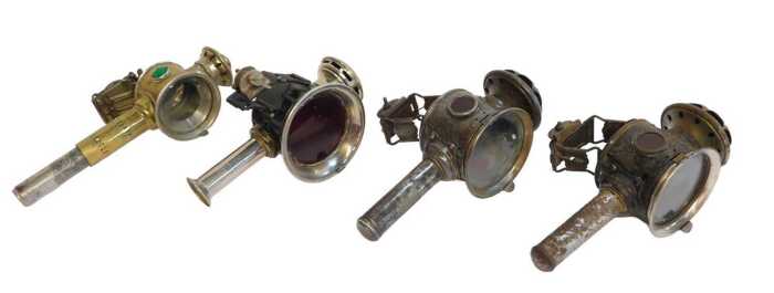 Four candle bicycle lamps, two for Luxor, 24cm high, a brass effect finish example, and another...