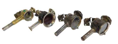 Four candle bicycle lamps, two for Luxor, 24cm high, a brass effect finish example, and another...