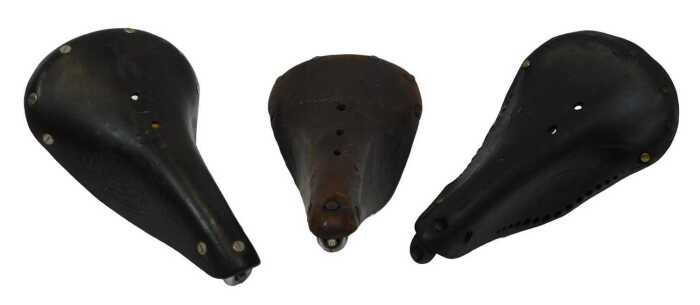 A Norex 38 leather saddle, with copper and brass rivets, an Ideal 80 leather saddle, and a...