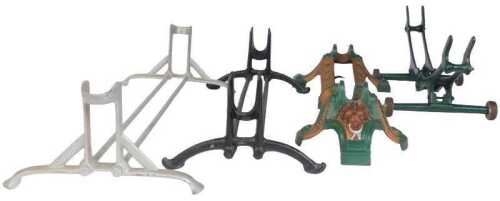 Various cast iron wheel stands, to include a green and bronze painted example with lion's head.