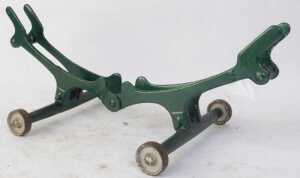 Various cast iron wheel stands, to include a green and bronze painted example with lion's head. - 4