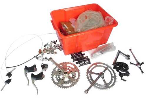 Bicycle spares, including pedals, brake handles, crank sets, etc. (1 box)