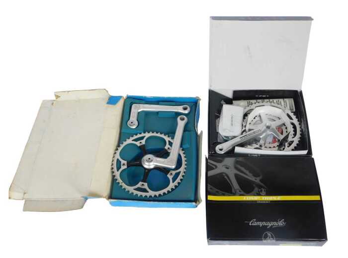 A Campagnolo Comp Triple crank set, a PMP crank set, and a Campagnolo Comp Triple tens crank set,...