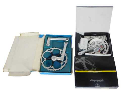 A Campagnolo Comp Triple crank set, a PMP crank set, and a Campagnolo Comp Triple tens crank set,...
