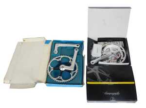 A Campagnolo Comp Triple crank set, a PMP crank set, and a Campagnolo Comp Triple tens crank set,...