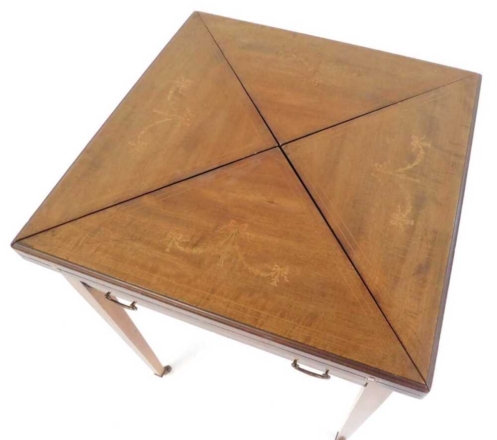 An Edwardian mahogany and inlaid envelope card table, the top inlaid ...