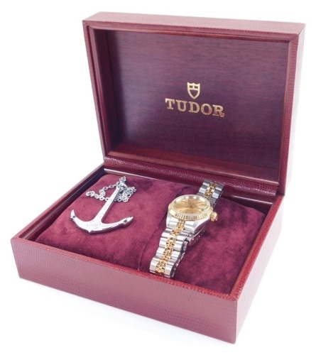 A Tudor Princess Oyster Date lady's bi-colour wristwatch, circular gilt dial with centre seconds, date aperture, rota self winding, on a bracelet strap, with 200 metre guarantee under water anchor pendant on chain, guarantee, booklet and pouch, cased and 