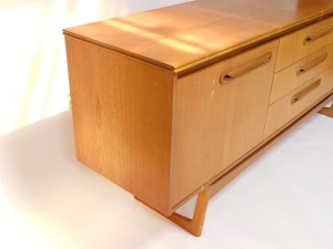 A Portwood Furniture vintage teak sideboard, with three central drawers flanked by a pair of cupboard doors, raised on U shaped ends, 75cm high, 184cm wide, 44cm deep. - 3